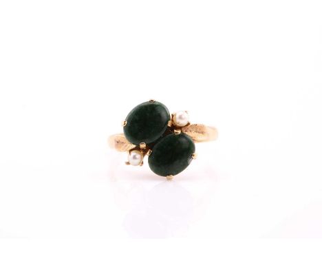 A jade and pearl ring, claw set with two oval jade panels and two 3mm seed pearls, to yellow precious metal mount, stamped 'M