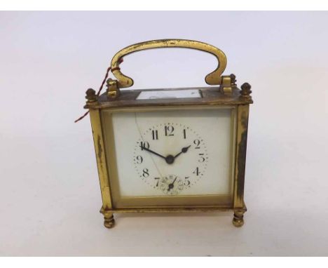 An early 20th Century French Lacquered Brass Carriage Alarm Clock, the rectangular case with carry handle and four finials, o