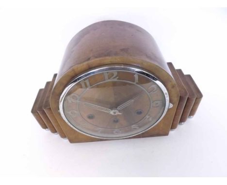 An early 20th Century Walnut and Chrome Mounted Triple Barrel Mantel Clock, the arched case with stepped side panels and rais