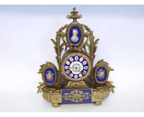 A late 19th Century French Gilt Spelter and Porcelain Mounted Mantel Clock, the drum case surmounted by portrait of a lady wi