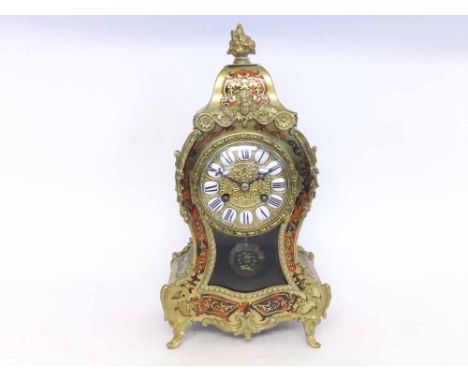 An early 20th Century Simulated Tortoiseshell and Brass Inlaid Mantel Clock, the waisted case with facetted pediment and flor