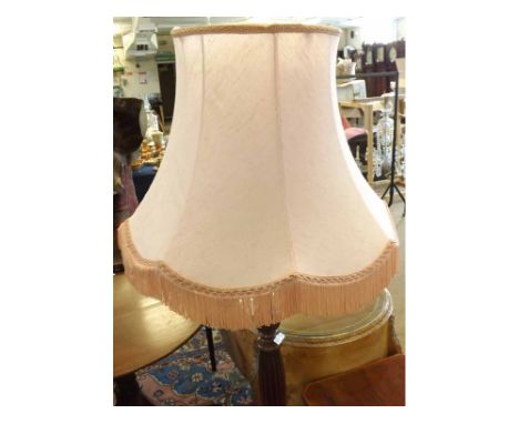 A 20th Century Standard Lamp with pink shade over a fluted column and spreading circular base 
