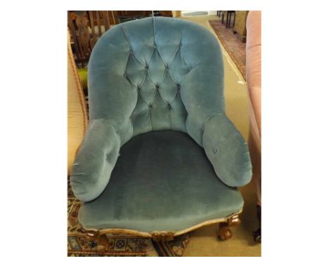 A Victorian blue button upholstered Armchair, raised on short cabriole legs and Brass casters   70-90 