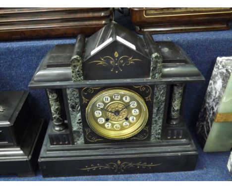 A late 19th Century Black and Green Variegated Marble Mantel Clock, the architectural case with overhanging cornice and shape
