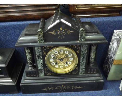 A late 19th Century Black and Green Variegated Marble Mantel Clock, the architectural case with overhanging cornice and shape