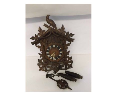 An early 20th Century Carved Walnut Wall Mounted Twin-Weight Cuckoo Clock, the architectural case with applied foliate and bi