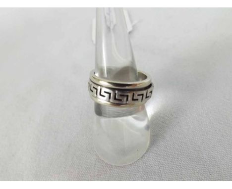 A Designer type mid-grade precious metal Ring, the overlaid centre section with pierced Grecian Key decoration, (this part wi