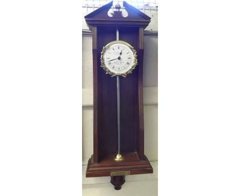 A reproduction Rack Clock, the mahogany case with breakarch pediment centred with an pineapple finial and with an applied bra