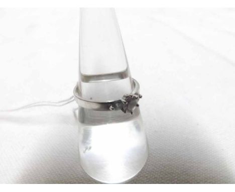 An unmarked precious metal Three Stone White Sapphire Ring 