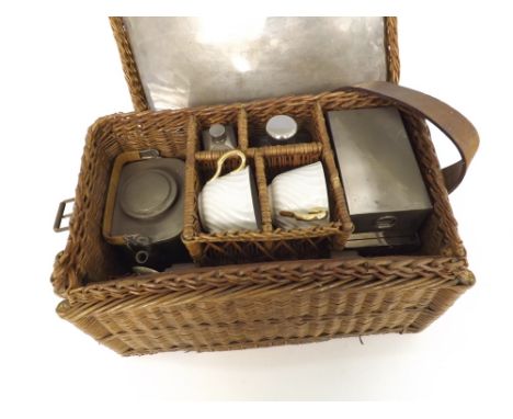 An unusual wicker cased Travelling Picnic Set, complete with various tins, cups, kettle etc, case 15" long
