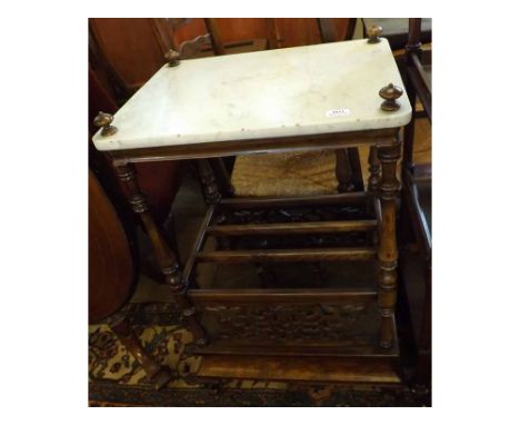 A Victorian Walnut Fruit Wood Canterbury with Marble top, the four corners with moulded finials and raised on ring turned spi