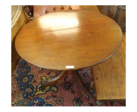 A 19th Century Mahogany circular pedestal Table, the plain top raised on a turned stem and tripod base with Brass paw feet, 3