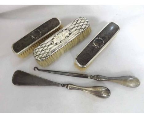 A Mixed Lot comprising: three assorted Silver-Backed Dressing Table Brushes, together with a further Silver-Handled Button Ho