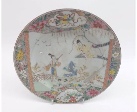 An 18th Century Chinese Circular Plate, painted in colours with scene of young lady in a garden and her suitor, the border wi