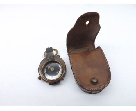An early 20th Century lacquered and patinated Brass Prismatic Compass, unsigned of typical circular form with bow suspension 