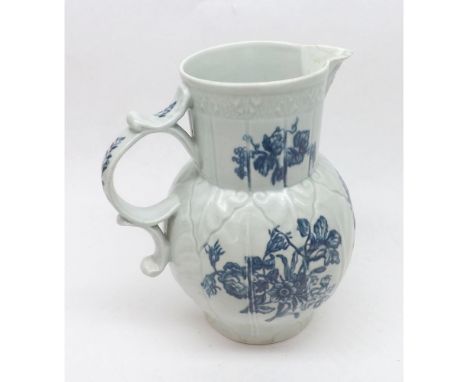 An 18th Century Worcester large balustered Mask Jug, decorated in underglaze blue on a moulded ground with sprigs and sprays 