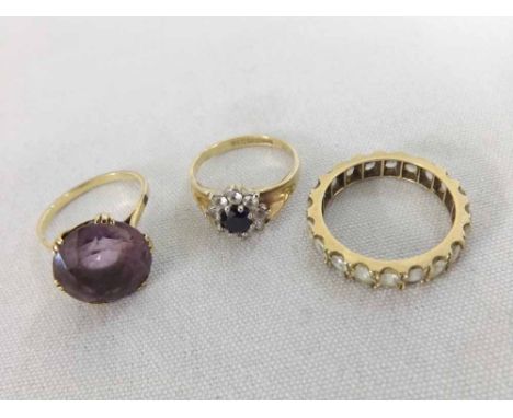 A unmarked yellow metal Ring set with a large circular Pale Amethyst; a hallmarked 9ct Gold Ring with centre Sapphire surroun