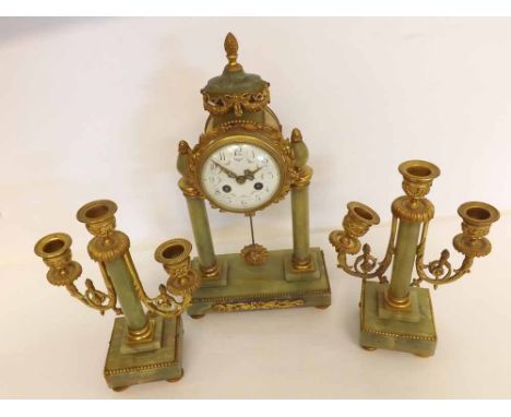 An early 20th Century Gilt Brass and Green Onyx Clock Garniture, the portico type clock case surmounted by an urn to a drum c