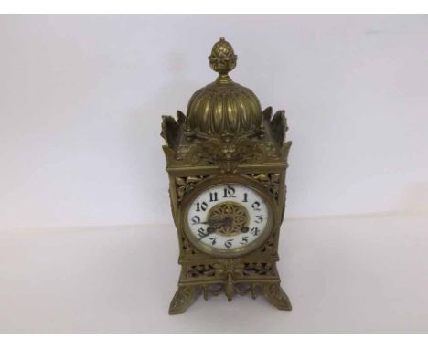 A late 19th Century Cast Brass Mantel Clock, of square form with domed pediment and pineapple finial, elaborately cast and ra