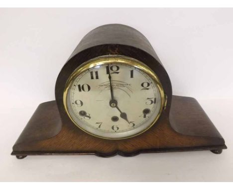 A mid-20th Century Oak Cased Triple Barrel Mantel Clock, the arched case on button feet to spun brass bezel with convex glass
