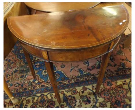 A 19th Century Mahogany and inlaid semi-circle Card Table, the fold top opening to a baize lined interior, the body raised on