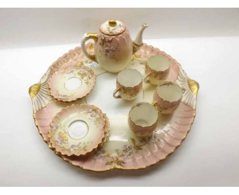An Aynsley Cabaret Set decorated with stylised foliage and gilt detail, on a pale background, comprising: Tray, Five Cups, Fo
