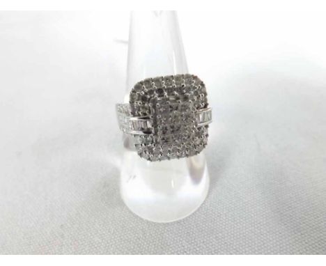 A hallmarked 18ct White Gold Multi-Diamond Set Panel Ring, featuring Princess, Brilliant and Baguette Cut Diamonds, of approx