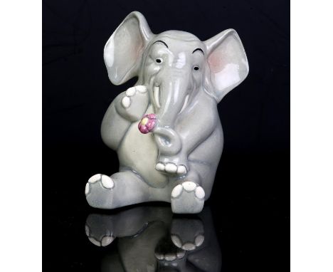 Lenci, Elephant, modelled seated holding a flower, painted marks, 8.5cm high Note: Catalogue No. 239Condition Report:  there 