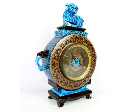 19th century majolica cased mantel clock of drum form, with dog of fo finial and mask handles, the silvered chapter ring with