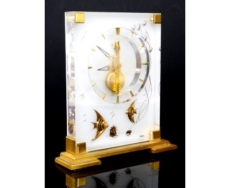 Jaeger-LeCoultre, a 'Marina' lucite and gilt brass mantel timepiece, the clear and white rectangular panels containing two gi