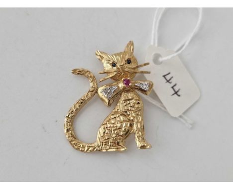 1950s Cat Brooch with exaggerated whiskers and bowtie set in diamonds withcentral ruby and Sapphire eyes 9ct 33mm 4.7g