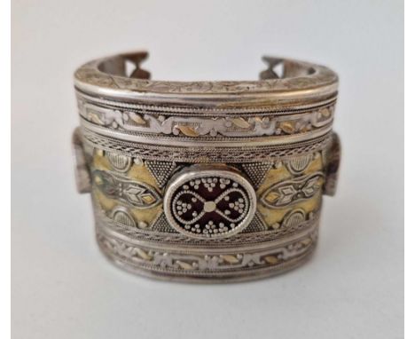A large ethnic silver bangle
