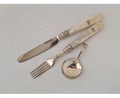 A Georgian M.O.P handled knife and fork, a caddy spoon with circular bowl
