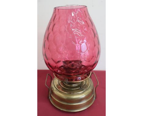 IMPROVED VENUS SAFETY LAMP, brass body with cranberry coloured shade (height 42cm) 
