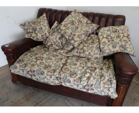 Early 20th C style oak framed two seat sofa with pleated leather back and various loose cushions 