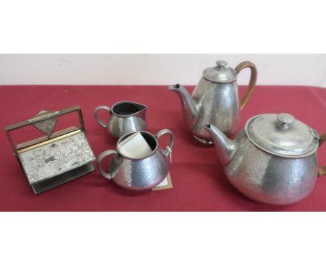 English hammered pewter four piece tea service stamped 0993, the hot water and teapot with wicker bound handles, and a metal 