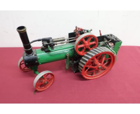Live steam model of a traction engine, probably scratch built, black and green body with red spoked wheels (39cm x 22cm x 17c
