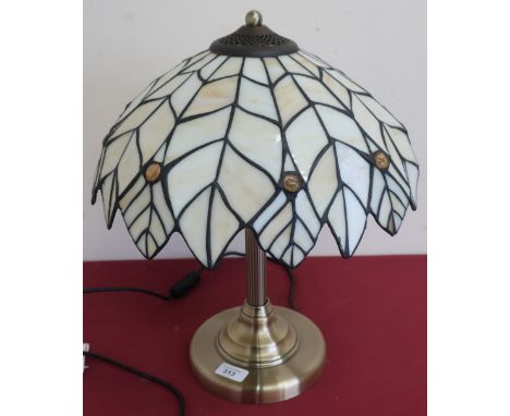 Table lamp with Tiffany style glass shade on brushed metal column support an circular base (45cm high) 