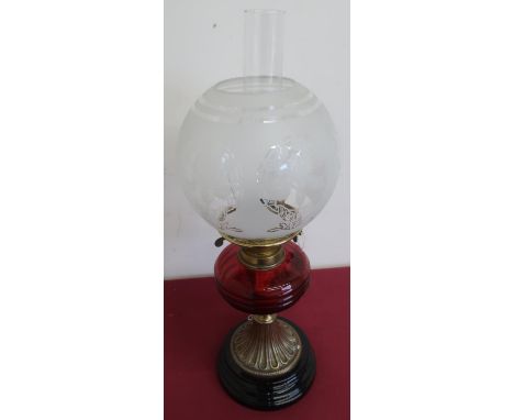 Late Victorian oil lamp with etched shade and red glass reservoir, on brass and slag glass circular stepped base (height 54cm
