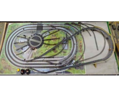 'OO' gauge model railway layout with central electrically operated turntable surrounded by concentric loops of track on a pri