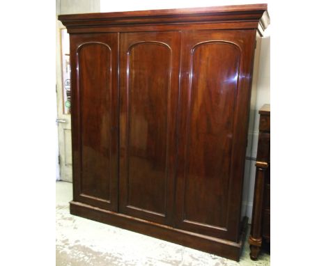 TRIPLE WARDROBE, Victorian mahogany with panel doors enclosing hanging space and four drawers, 211cm H x 195cm x 60cm.