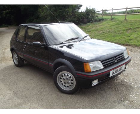 A 1985 Peugeot 205 GTi 1.6, registration number B30 XWL, black. Launched in 1983, Peugeot's 205 GTi has become one of, if not