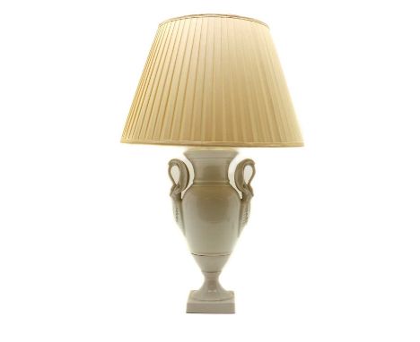 A Limoges blanc-de-chine porcelain table lamp,20th century, French, of urn shape with neoclassical swan and anthemion handles
