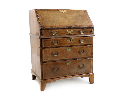 A George III crossbanded yew wood bureau,the fitted interior with a well over a dummy drawer, three long drawers and bracket 
