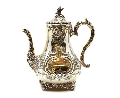 An silver coffee pot,by Johnson, Durban &amp; Co Ltd, Birmingham 1904, the hinged cover with falcon finial above a baluster b