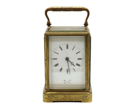 An engraved brass carriage clock,the enamel dial inscribed 'Hall & Co, King St, Manchester', the movement striking the hours 