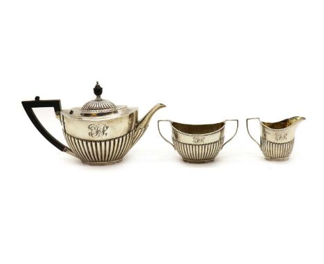 A Victorian silver three piece tea service,by Mappin Brothers, Sheffield 1899, with engraved initials above reeded decoration