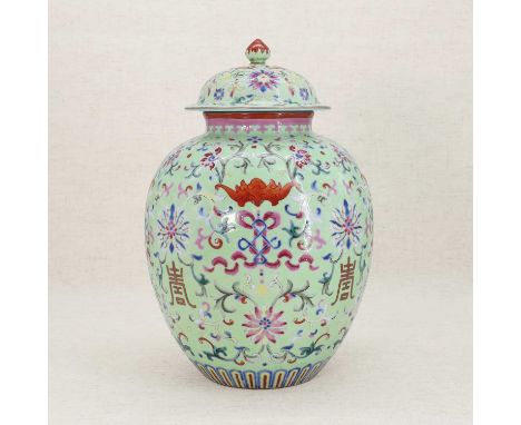 A Chinese famille rose jar and cover, of ovoid form, painted with bats amongst scrolling lotus against a green ground, the do