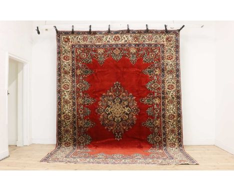 A Mahal carpet,of recent manufacture, with a floral medallion, to a plain red field, and foliate borders,263 x 344cmCondition