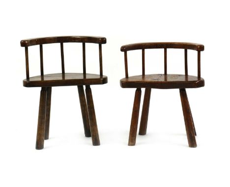 A near pair of oak stick back chairs,20th century, each with a thick slab seat,largest 56cm wide30cm deep72cm high, seat 46cm